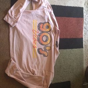 A pink crop top that has a 90’s style to it